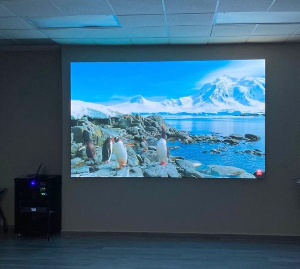LED screen installed in a boardroom showing a landscape image