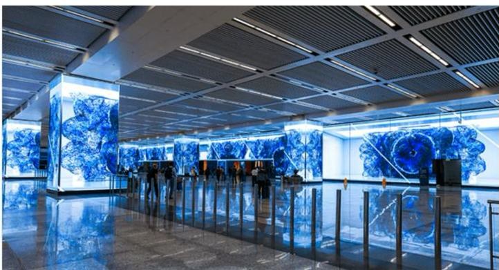 Curved LED wall in the entrance lobby of a convention center, along the entry checkpoints