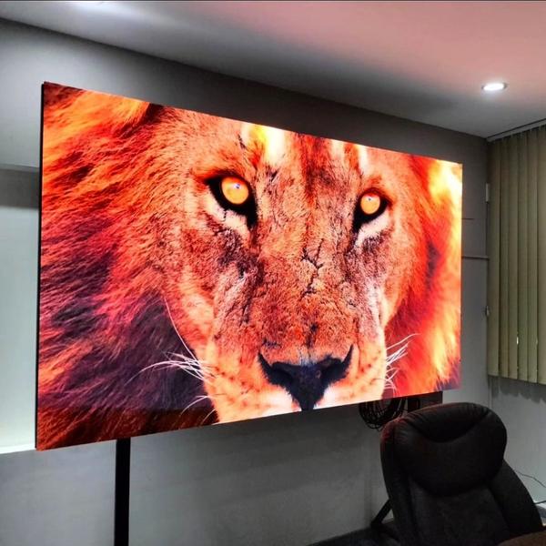 Fine-pitch LED screen in a meeting room showing a highly detailed image of a lion