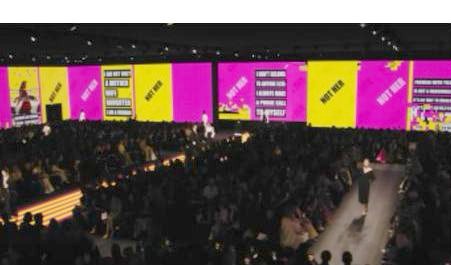Perimeter LED screens above a large audience at an events venue