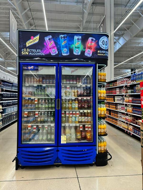 Curved LED screen installed above refrigerators in a supermarket